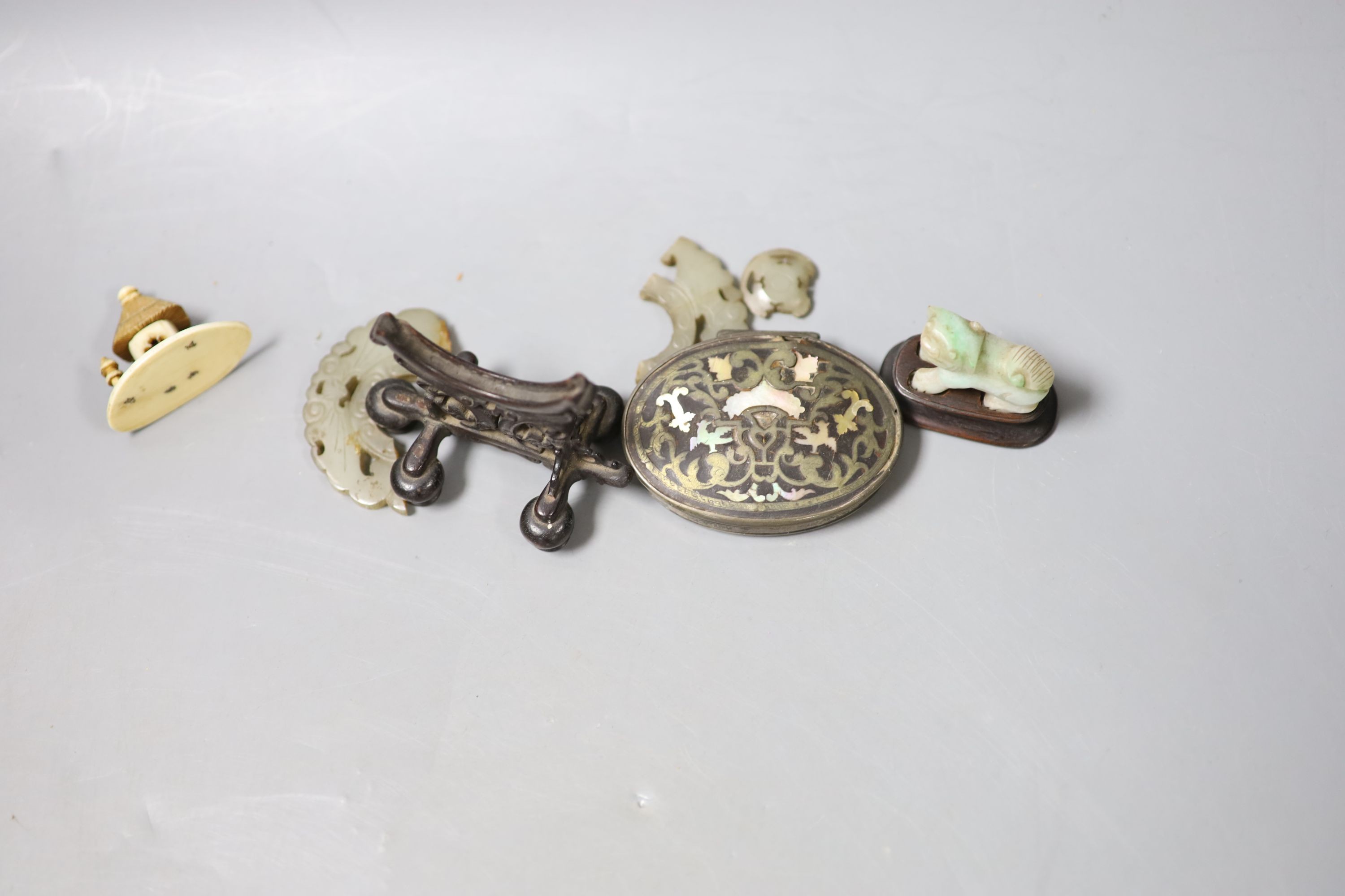 A Chinese small celadon jadeite lion on stand, a small jade circular plaque on stand (damage) and sundry items